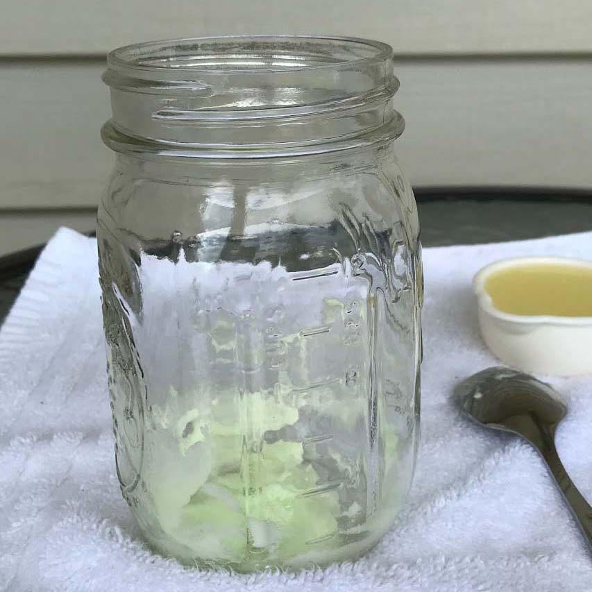 An empty mason jar on a white towel