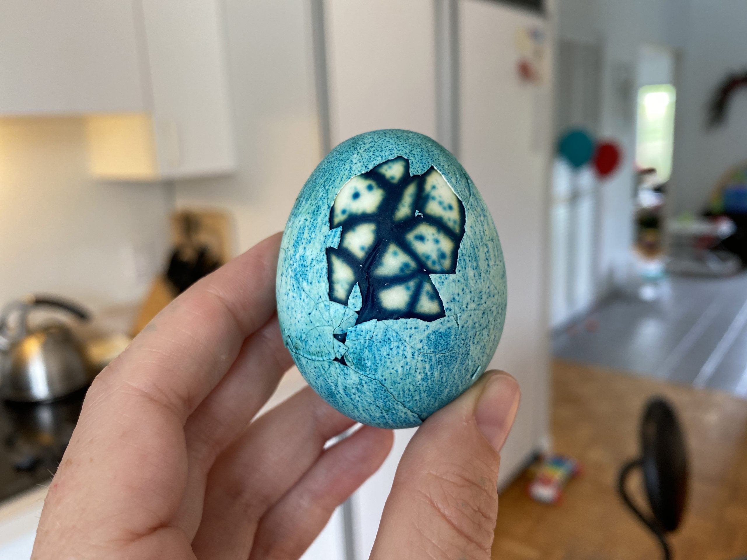 hard boiled egg dyed blue with marble pattern