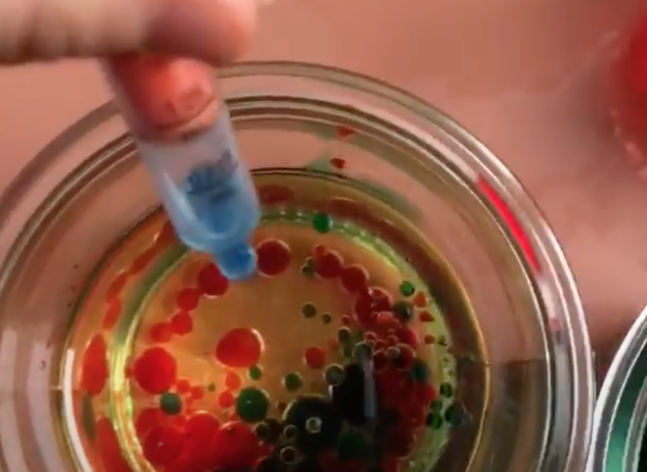 Food coloring drops going into water