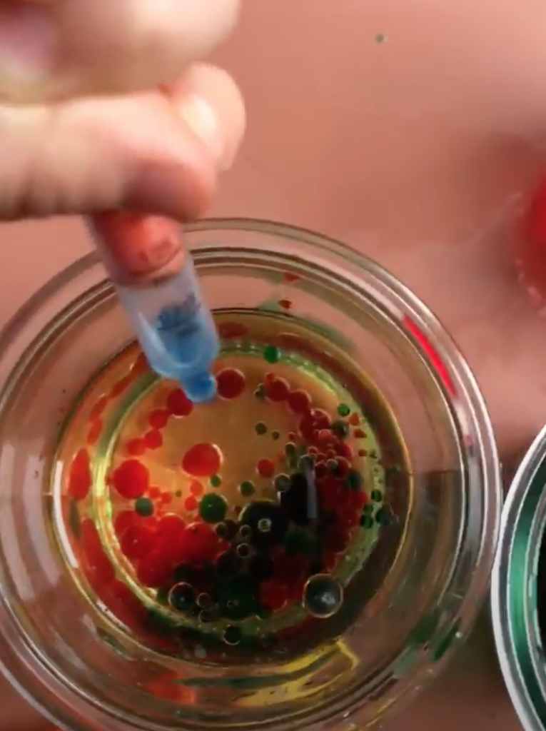Food coloring drops going into water