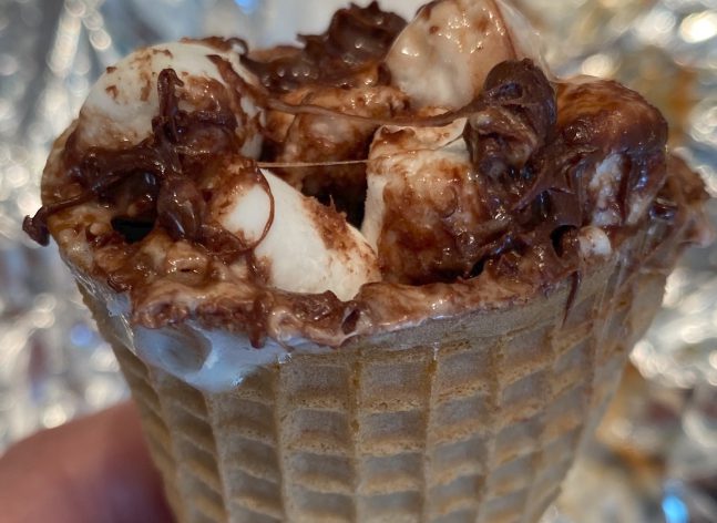 photo of a ice cream cone with cholocale and marshmallows