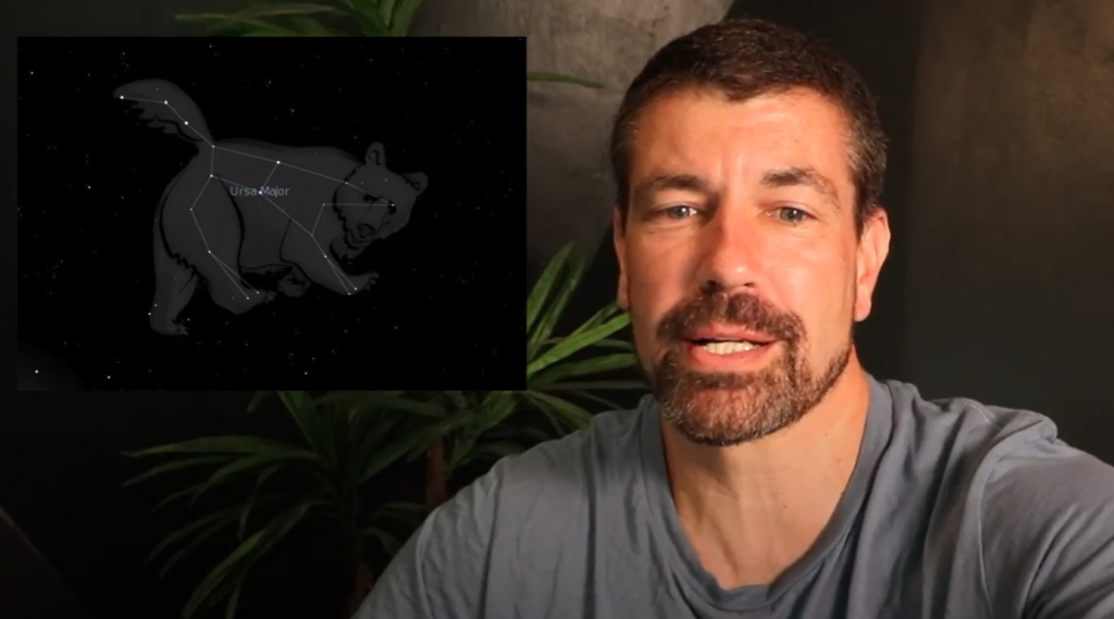An adult speaks. Over his shoulder is an images of a night sky and the constellation of a big bear