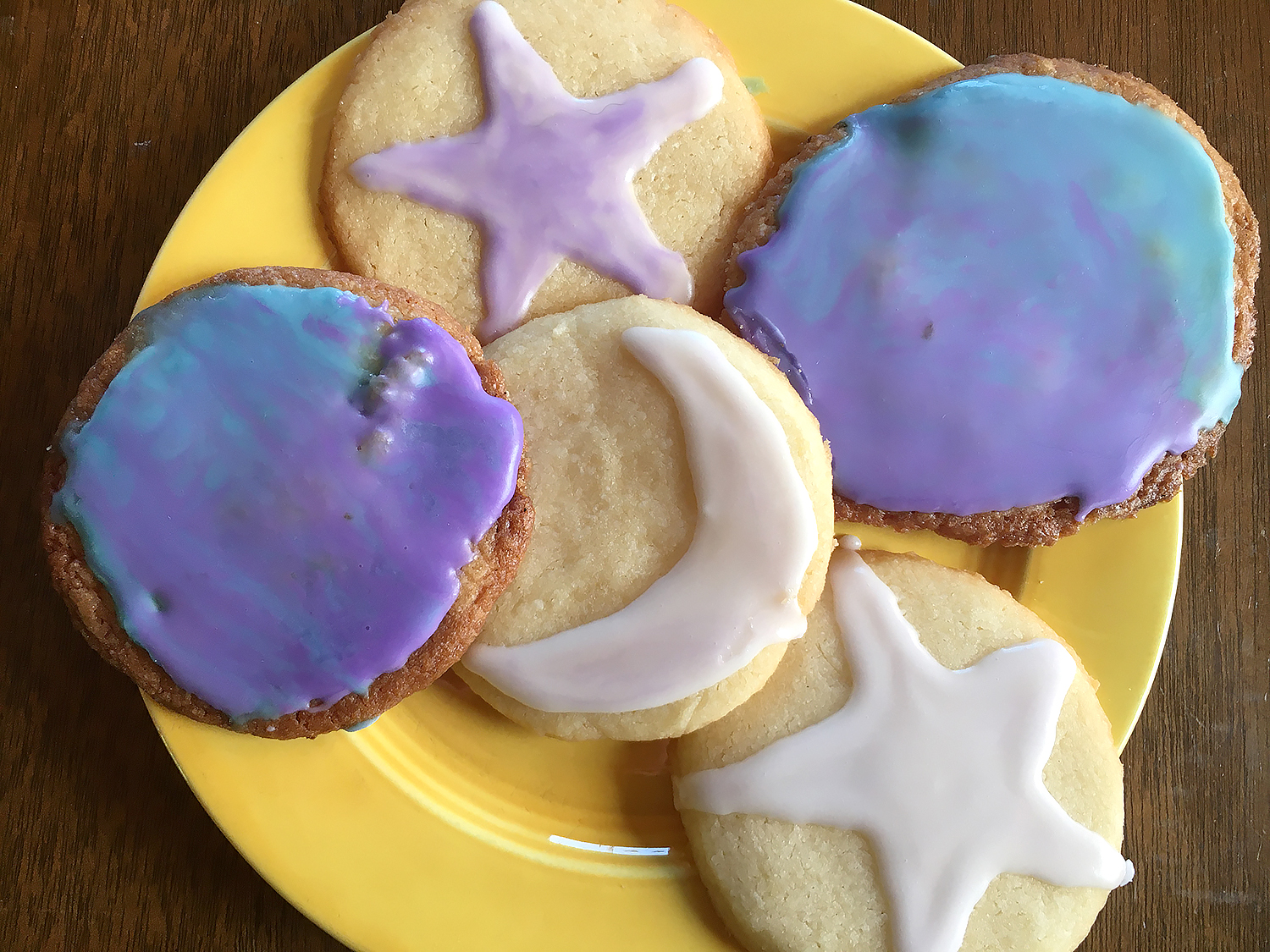 Cookies decorated to look like planets, stars and moons